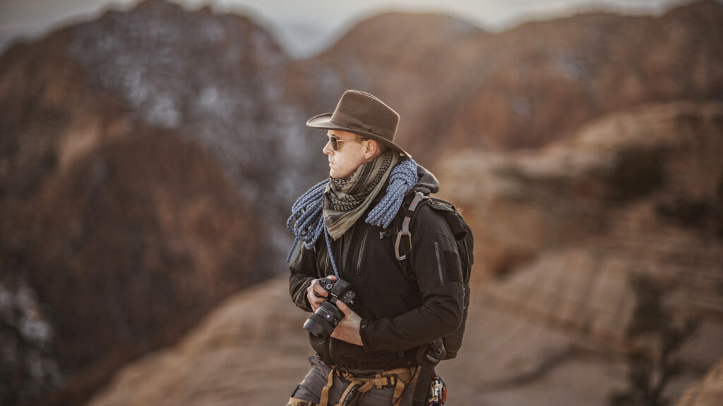 Rex Jones, portrait photography in Utah, capturing an adventurous self portrait with climbing gear in a mountainous landscape.