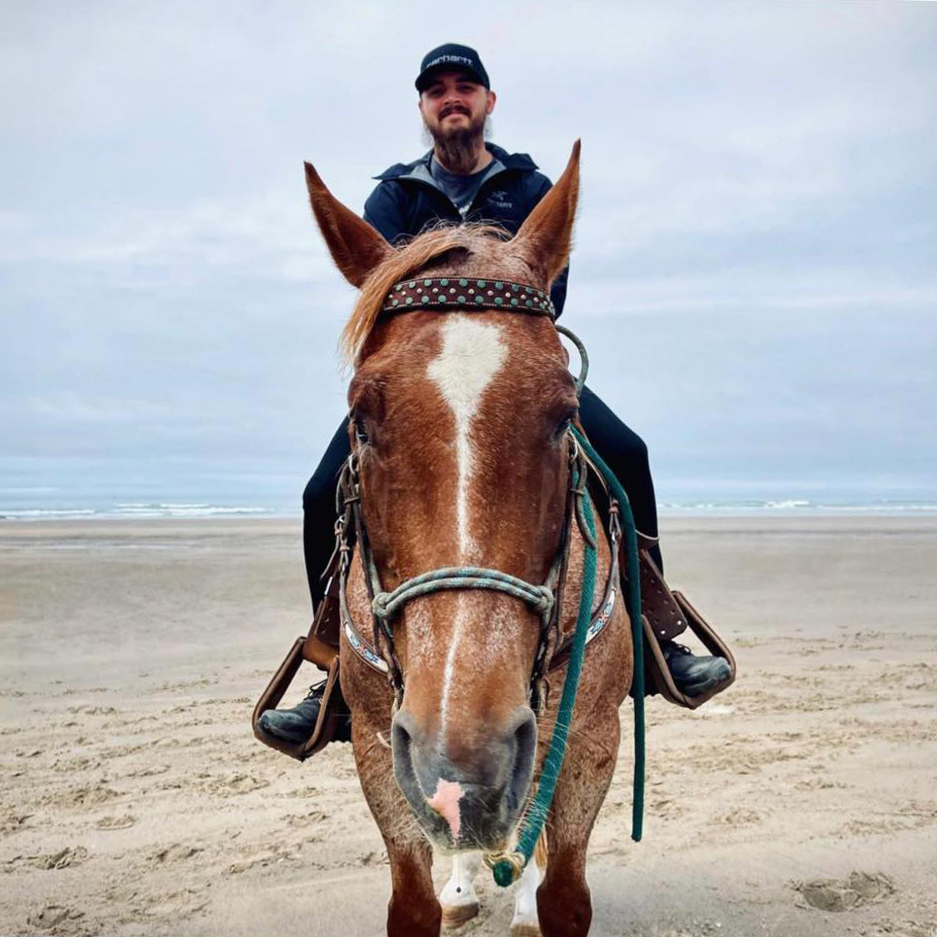 Kenton Brower, a Gandalf in marketing, riding a horse on a beach, ideal for creative marketing and personal branding projects